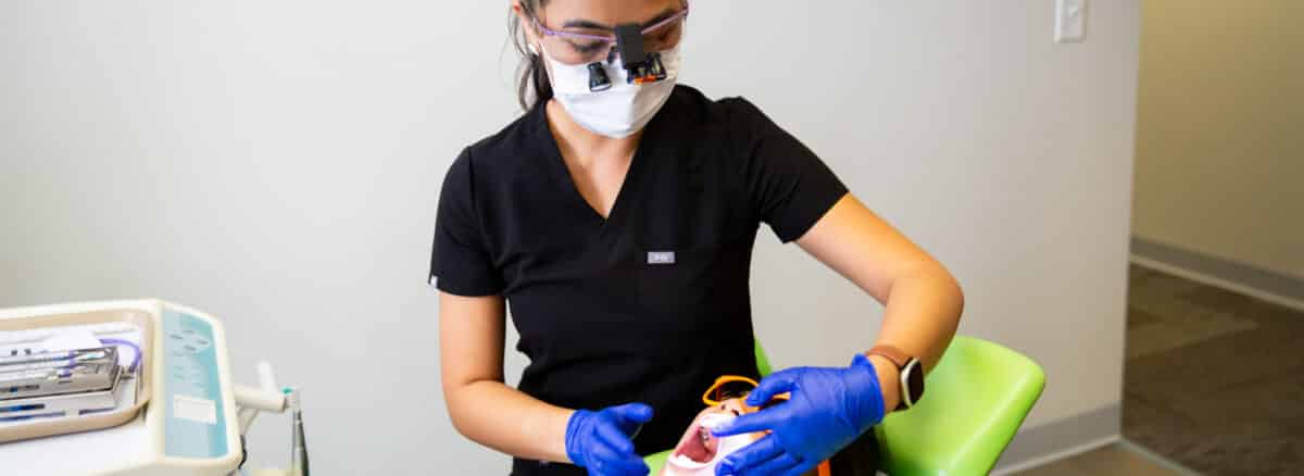 Pediatric dentist doing a routine examine on a young patient