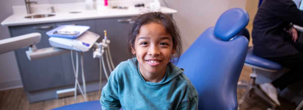 Happy child smiling during a routine pediatric dentist visit