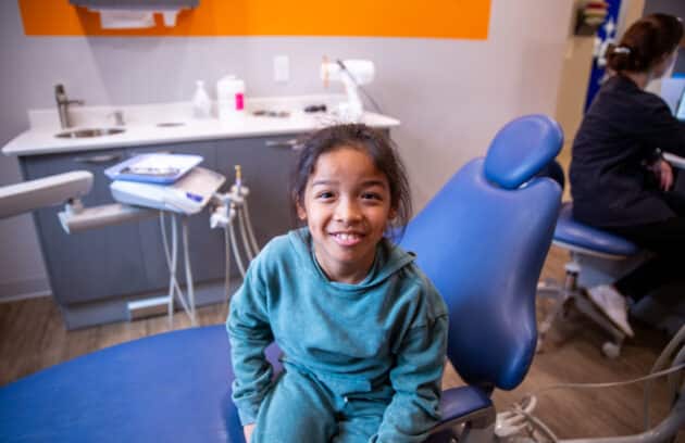 Happy child smiling during a routine pediatric dentist visit